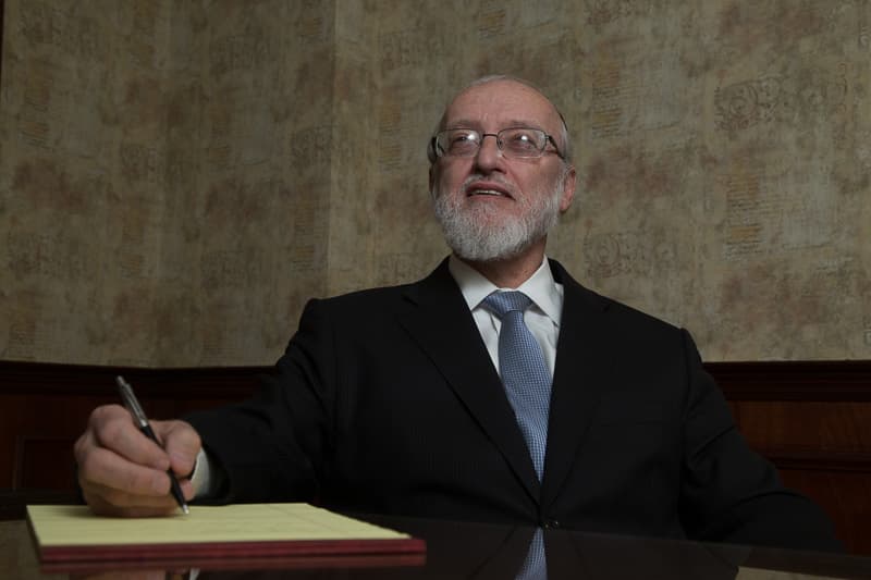 Nachman Caller at his desk